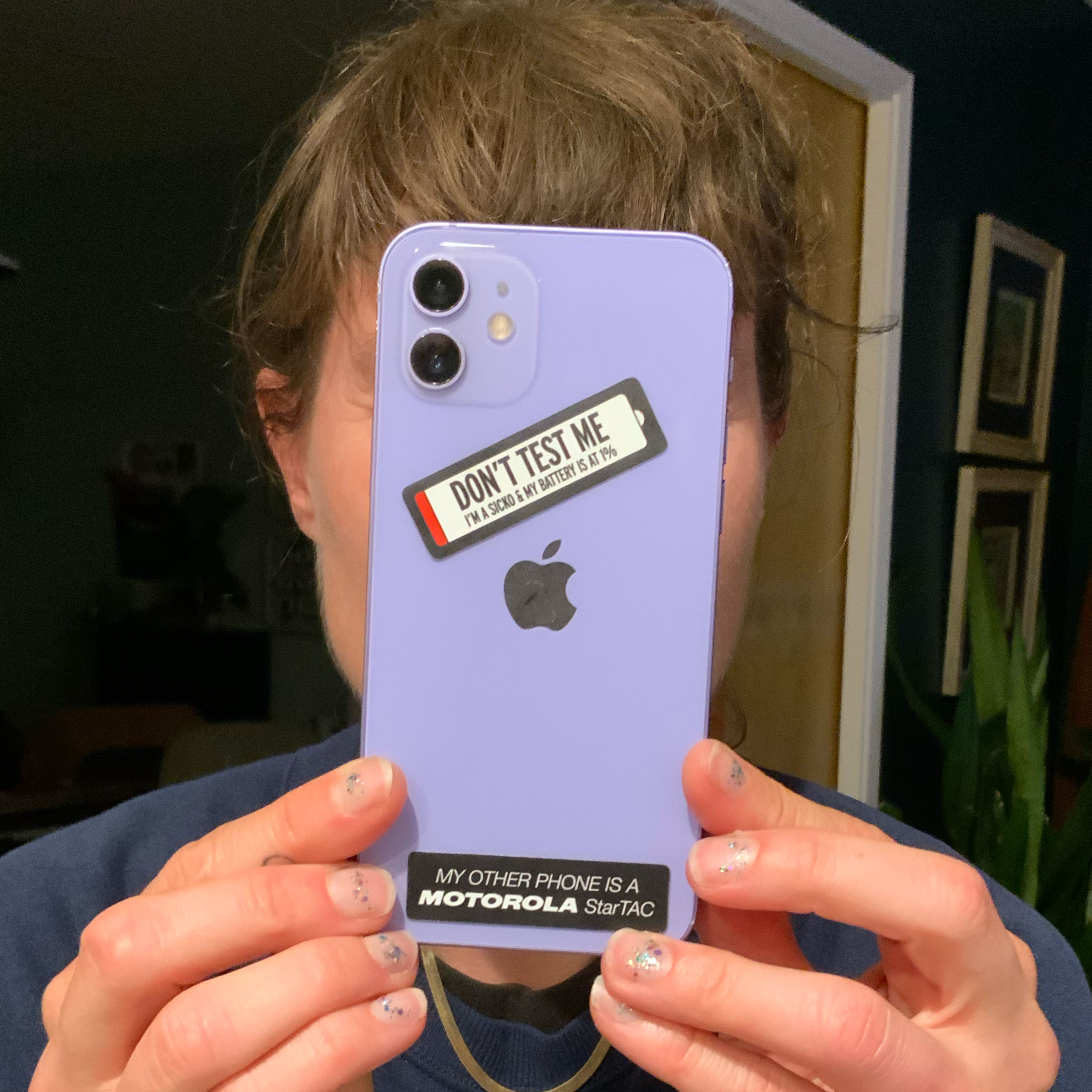 Kathryn wears two stickers on her purple phone.